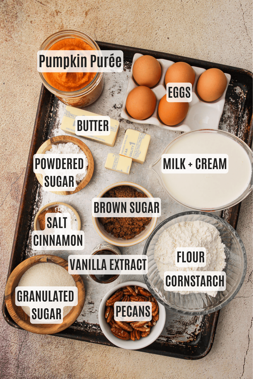 Ingredients on a sheet tray for pumpkin cream pie.