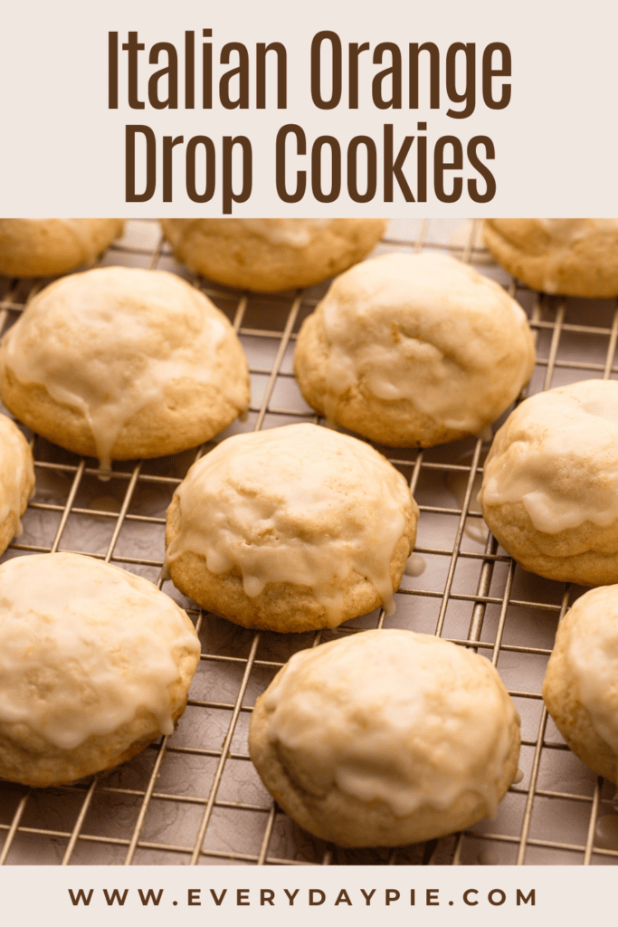 Baked and glazed orange cookies on a cooling rack.