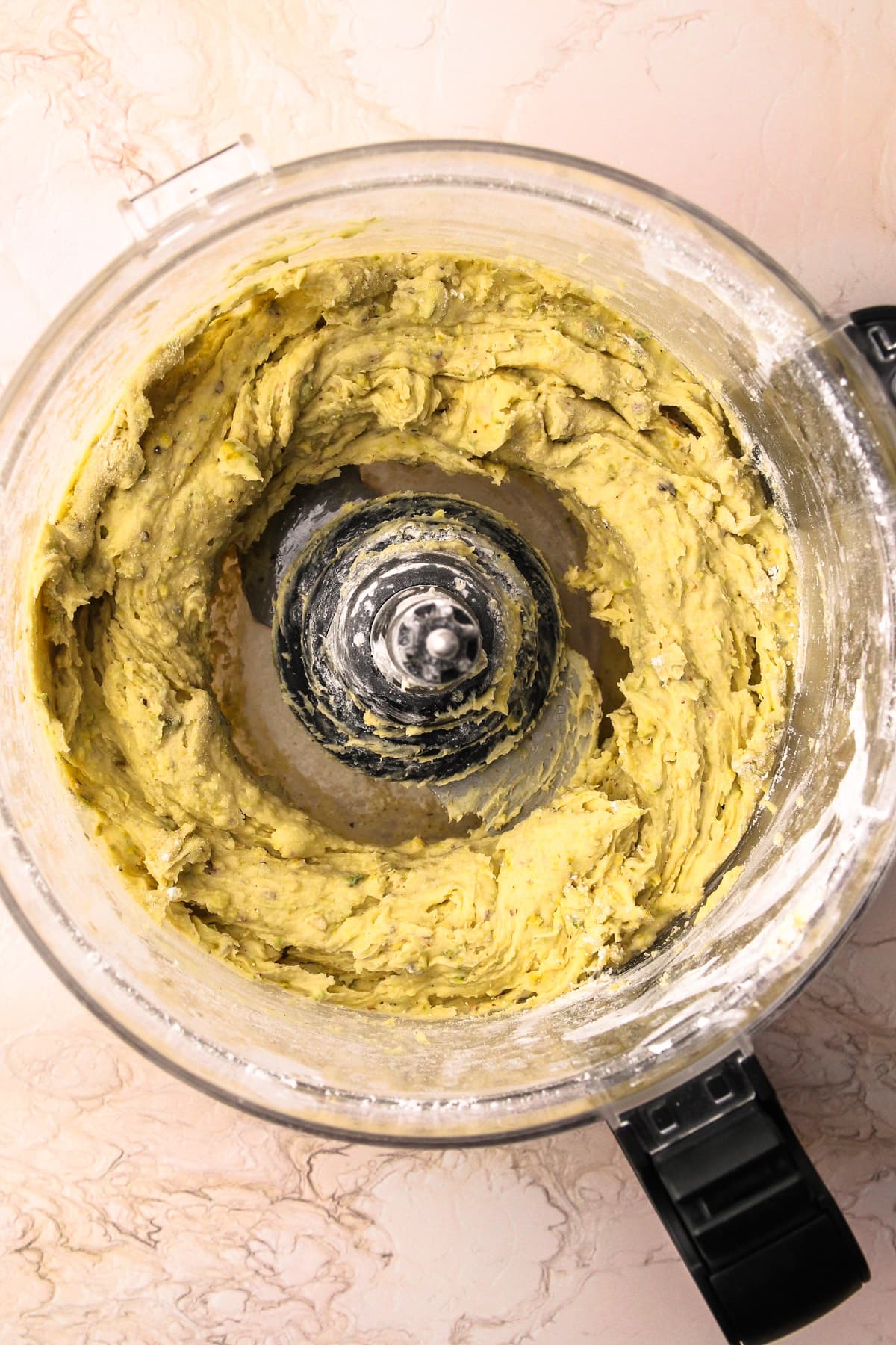 Pistachio shortbread cookie dough in a food processor.