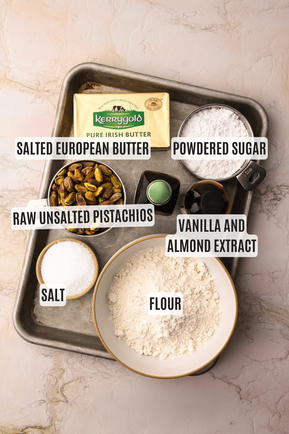Ingredients for pistachio shortbread cookies on a sheet tray.