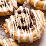 A baked and glazed puff pastry cinnamon roll.