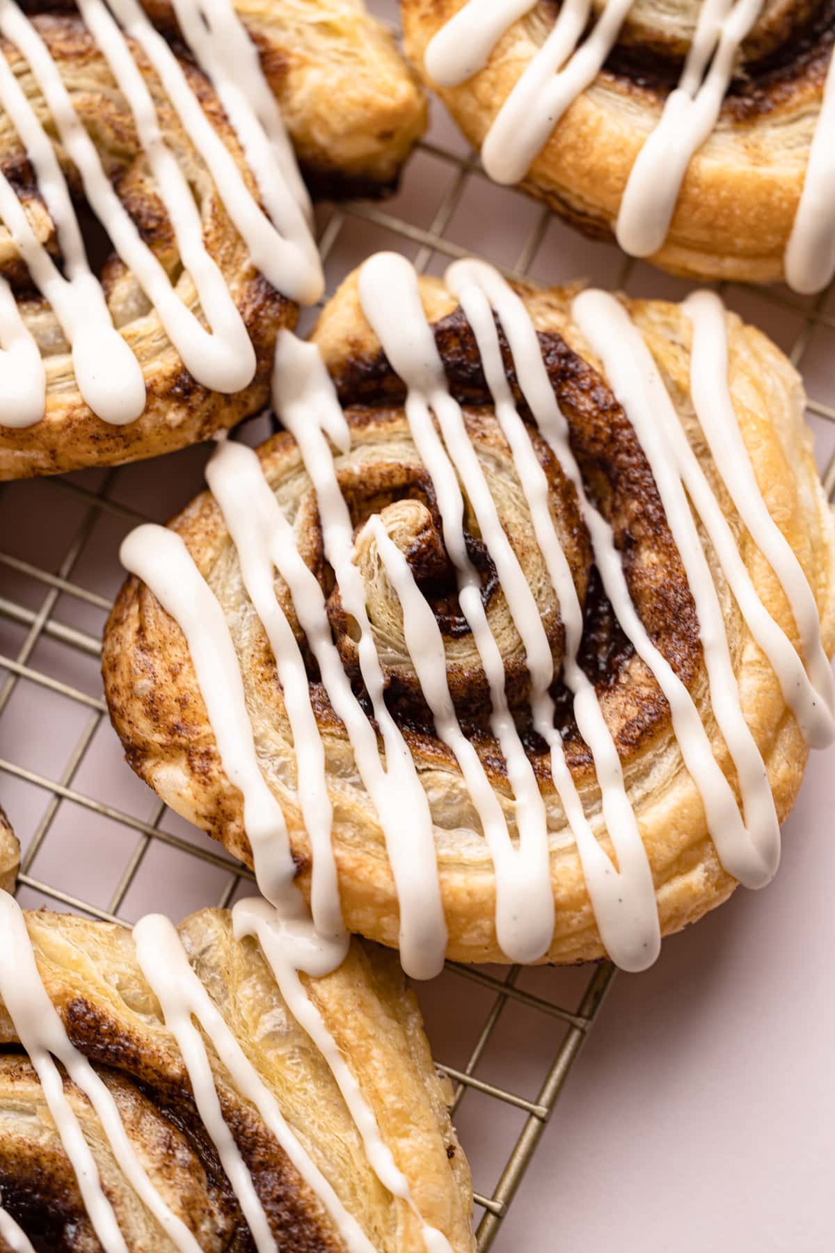 A baked and glazed puff pastry cinnamon roll.