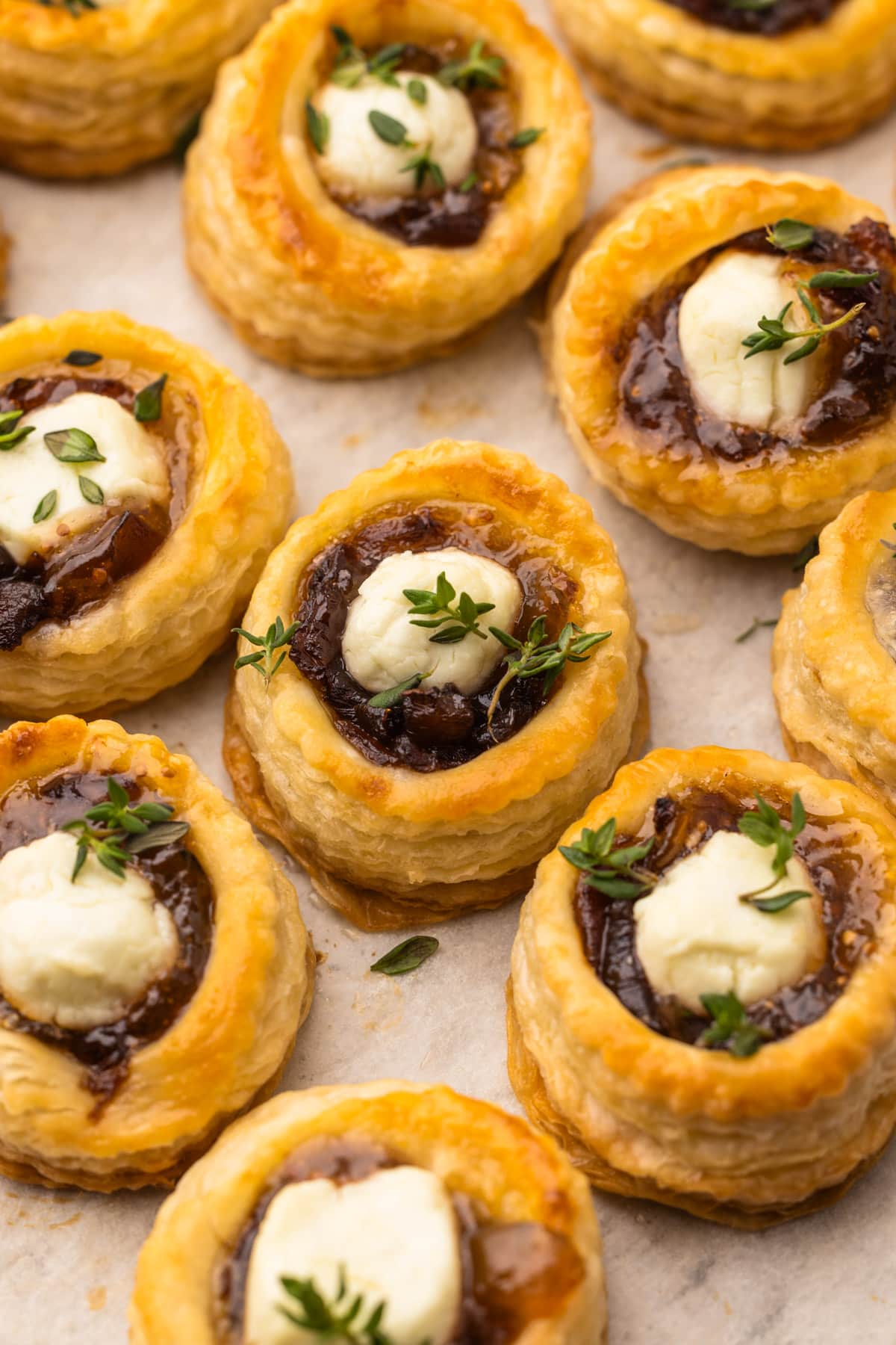 Baked puff pastry goat cheese and fig tarts with a sprinkle of thyme.