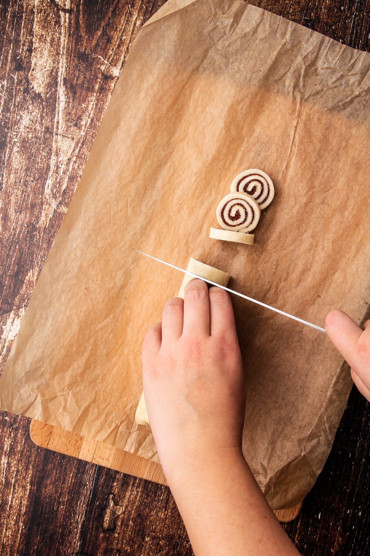 Slicing into cinnamon roll pie crust cookie dough.