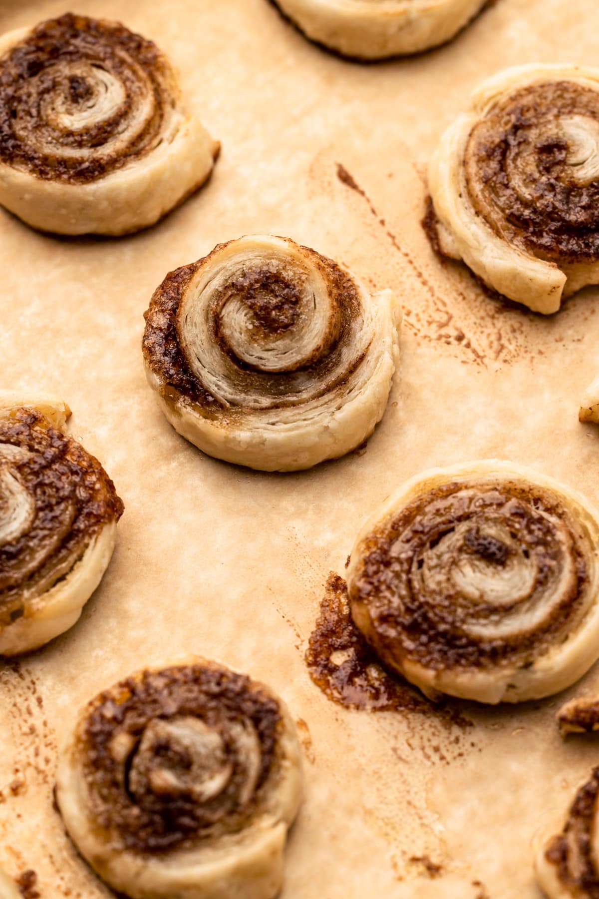 Baked pie crust cinnamon roll cookies on a sheetpan.