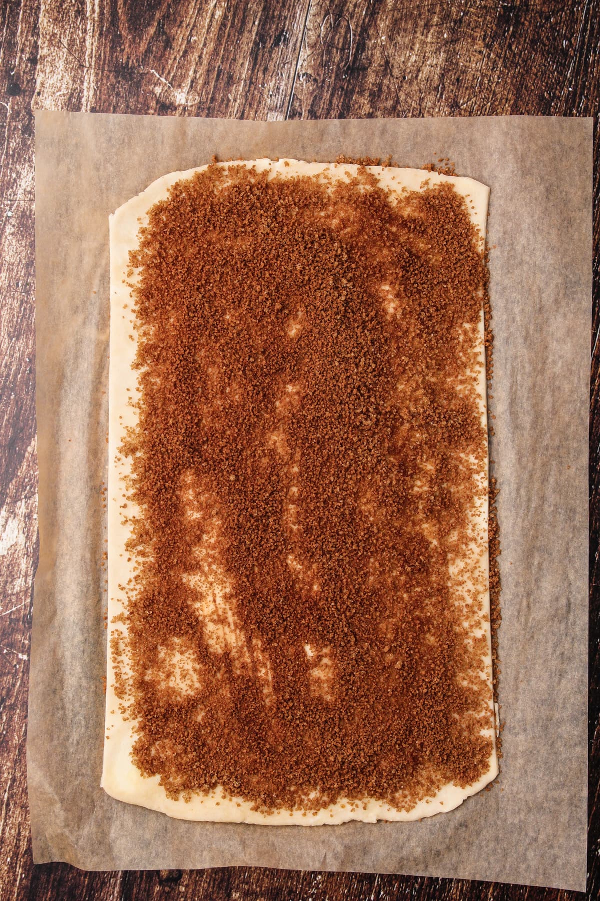 Pie crust rolled out and covered with cinnamon sugar to make cookies.