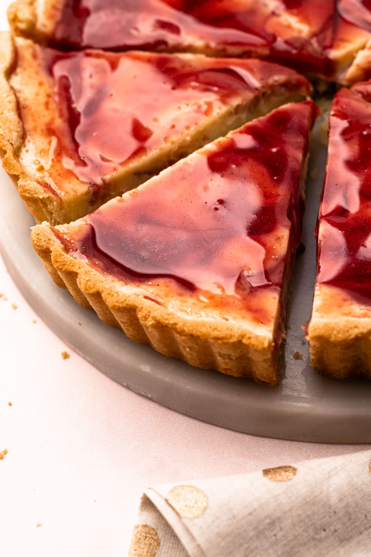 A baked roasted plum pie cut into slices.