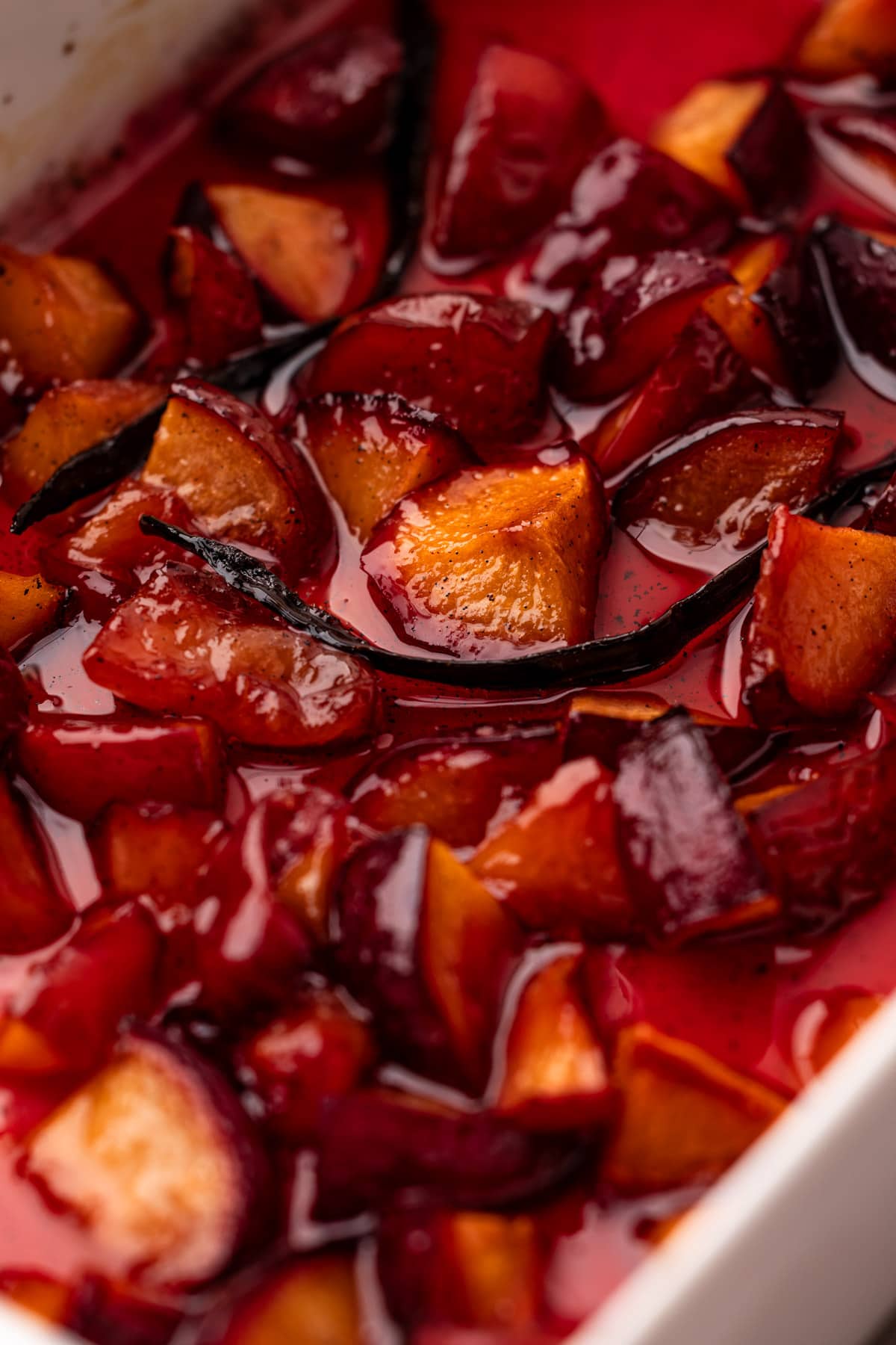 A baking dish of roasted plums for roasted plum pie.