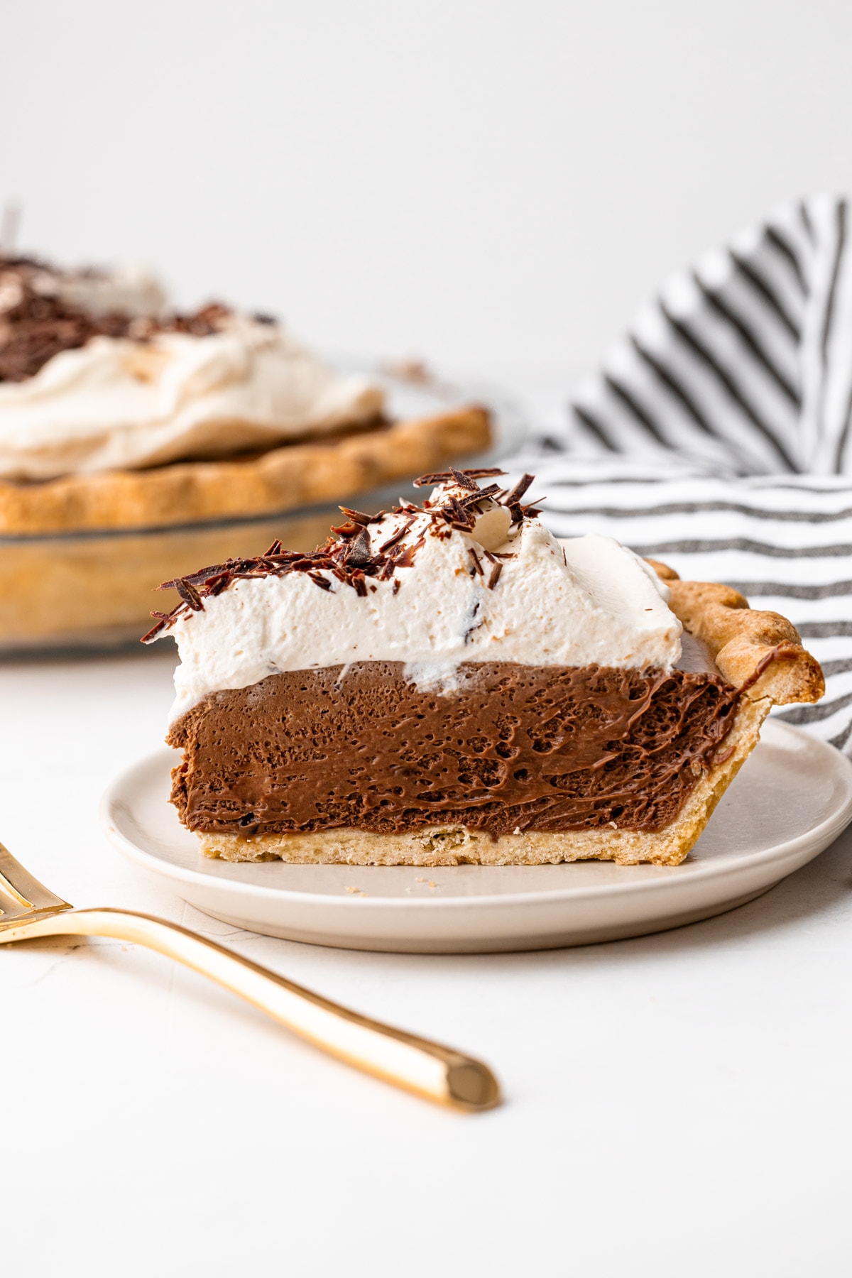 A slice of chocolate silk pie on a plate.