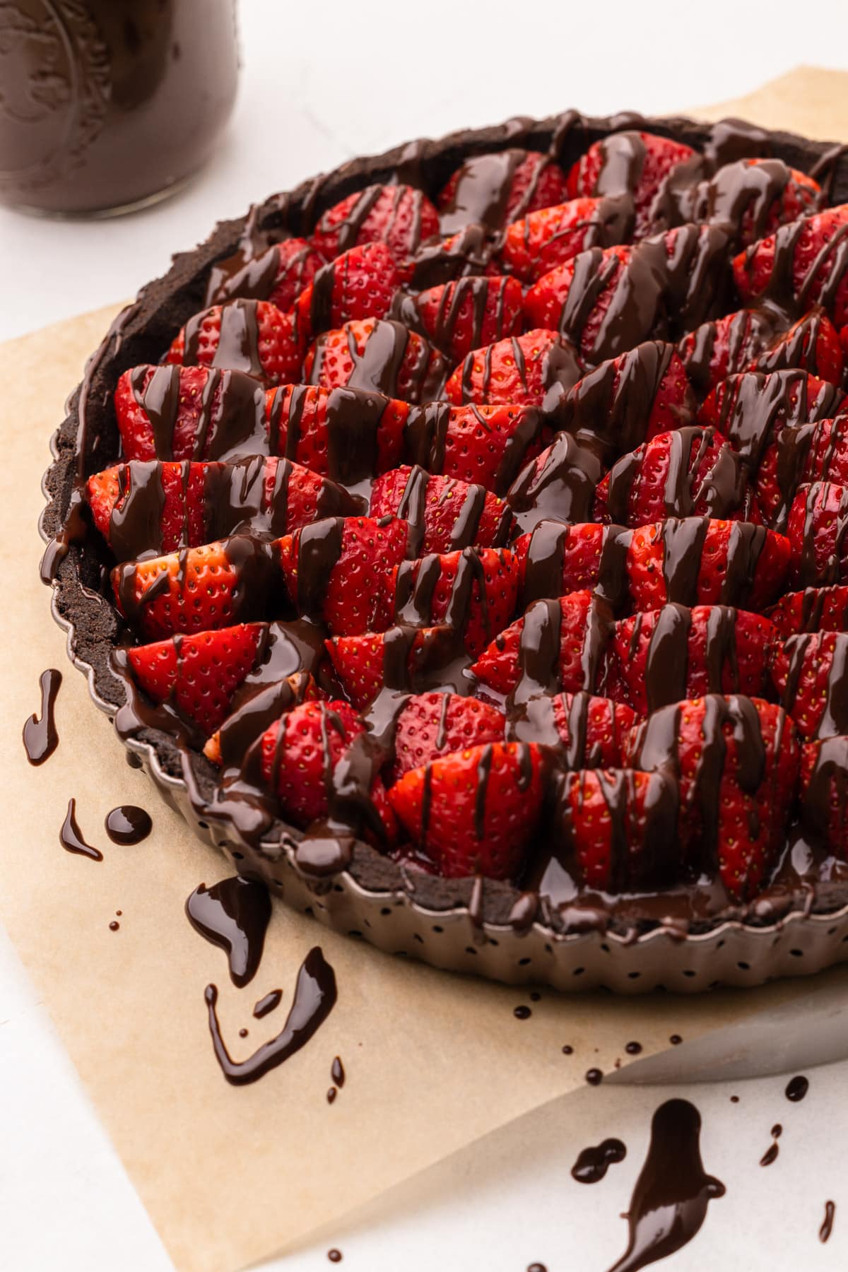 A chocolate strawberry pie drizzled with melted chocolate.