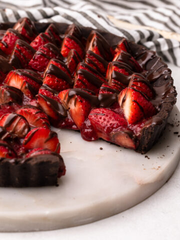 A chocolate strawberry pie drizzled with melted chocolate.