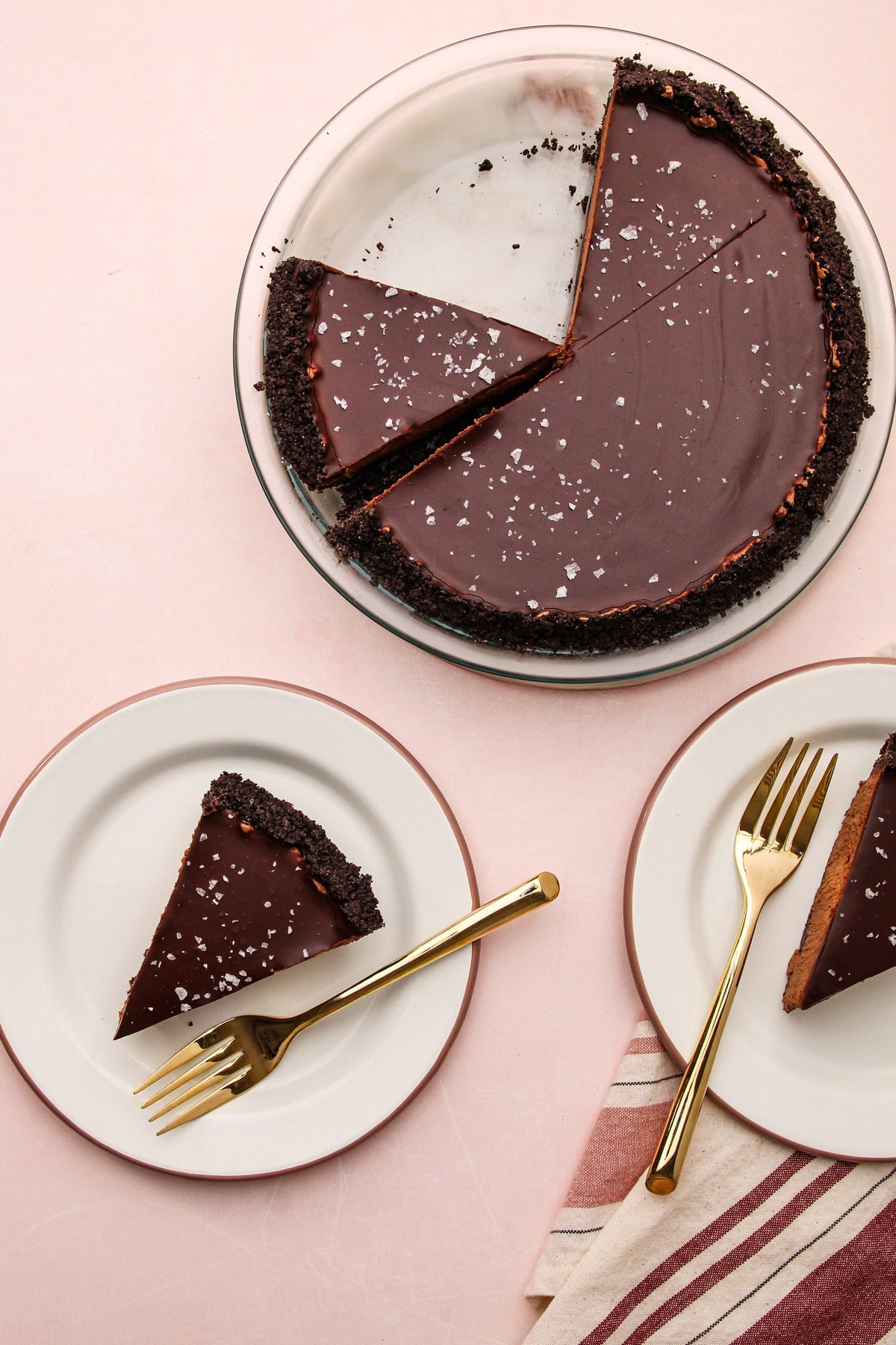 An easy chocolate pie in a pie plate, with slices next to it on small plates with forks.