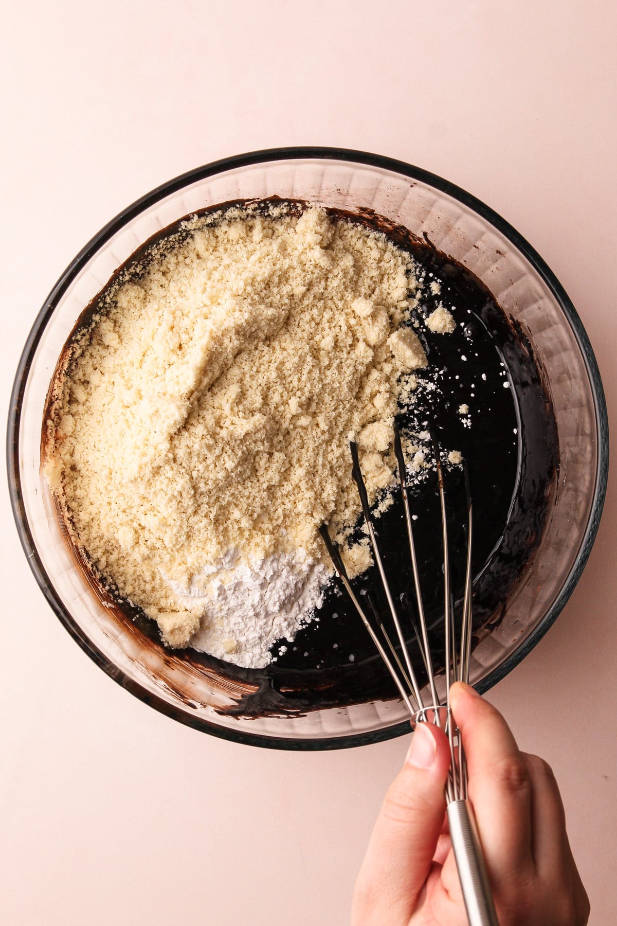 Whisking the dry ingredients into almond flour brownies.