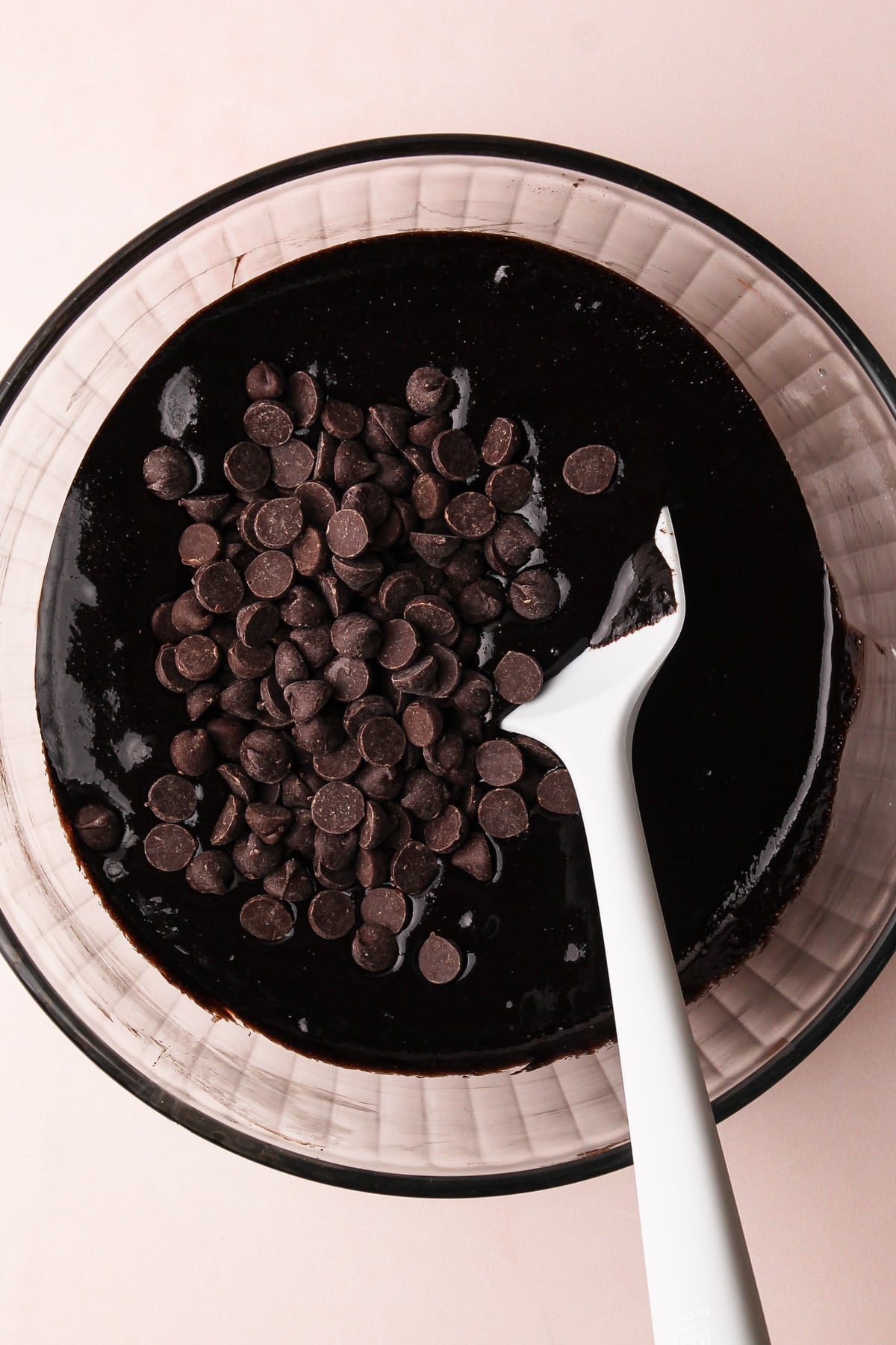 Stirring chocolate chips into almond flour brownie batter.