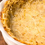 A potato pie crust fully baked in a pie tin.