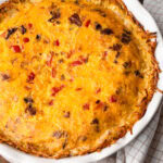 A fully baked breakfast pie with bacon and cheese puffed straight out of the oven.