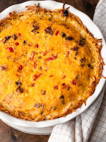 A fully baked breakfast pie with bacon and cheese puffed straight out of the oven.