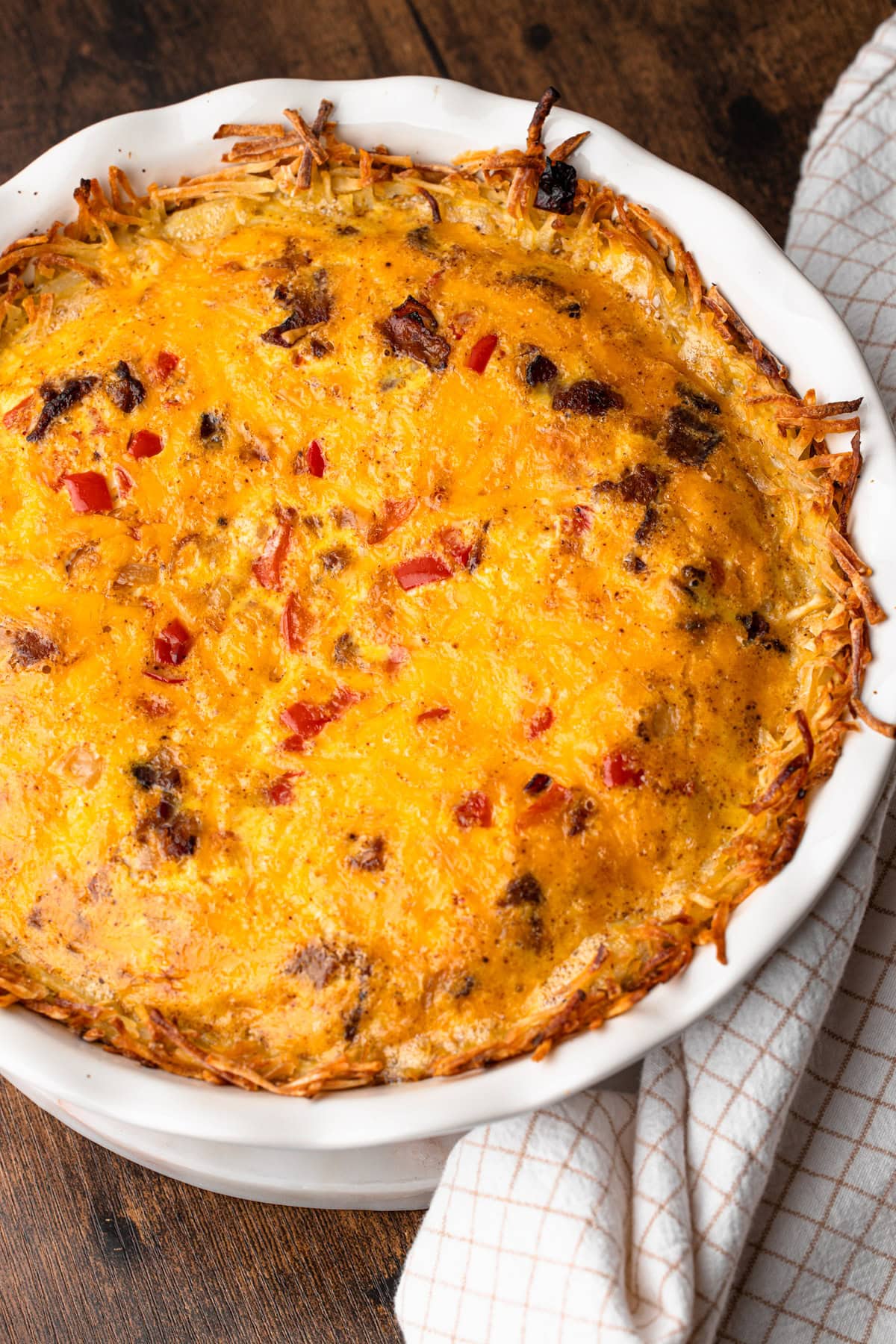 A fully baked breakfast pie with bacon and cheese puffed straight out of the oven.