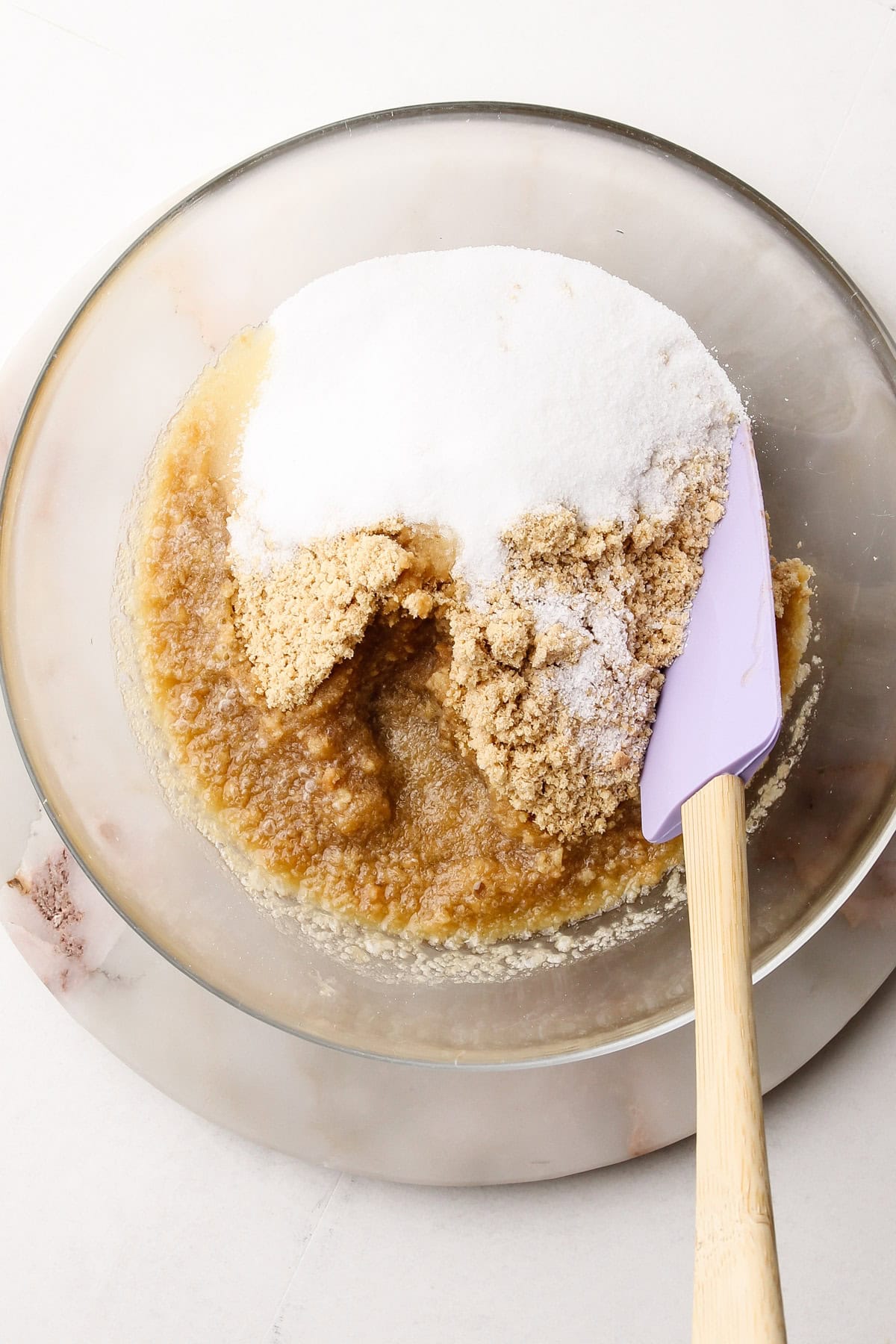 Mixing together an animal cracker crumb crust.