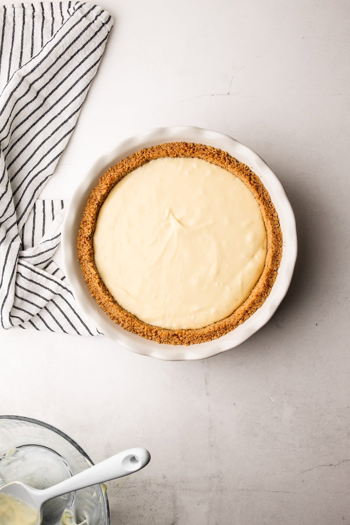 An unbaked cheesecake pie filling.