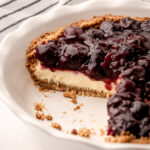 A slice of cherry cheese pie in a crunchy crumb crust.