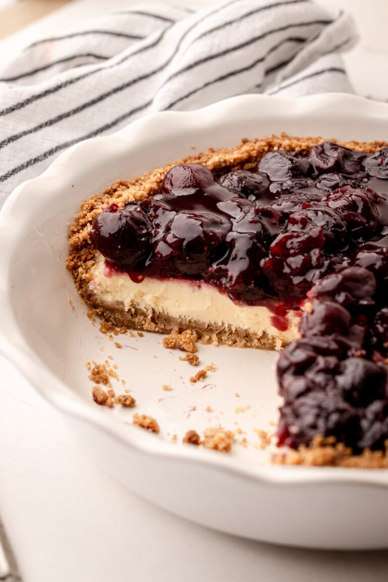 A slice of cherry cheese pie in a crunchy crumb crust.