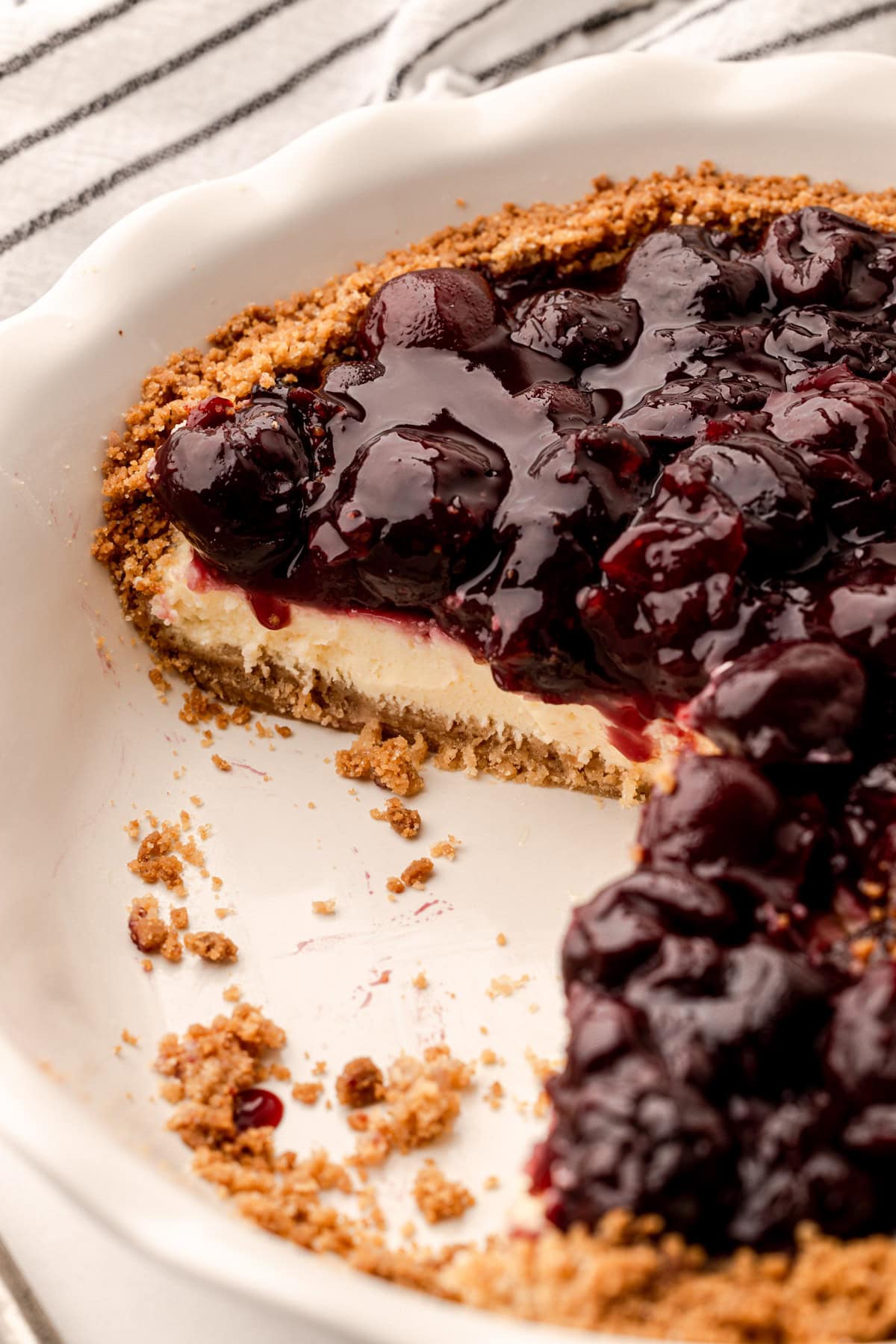 A slice of cherry cheese pie in a crunchy crumb crust.