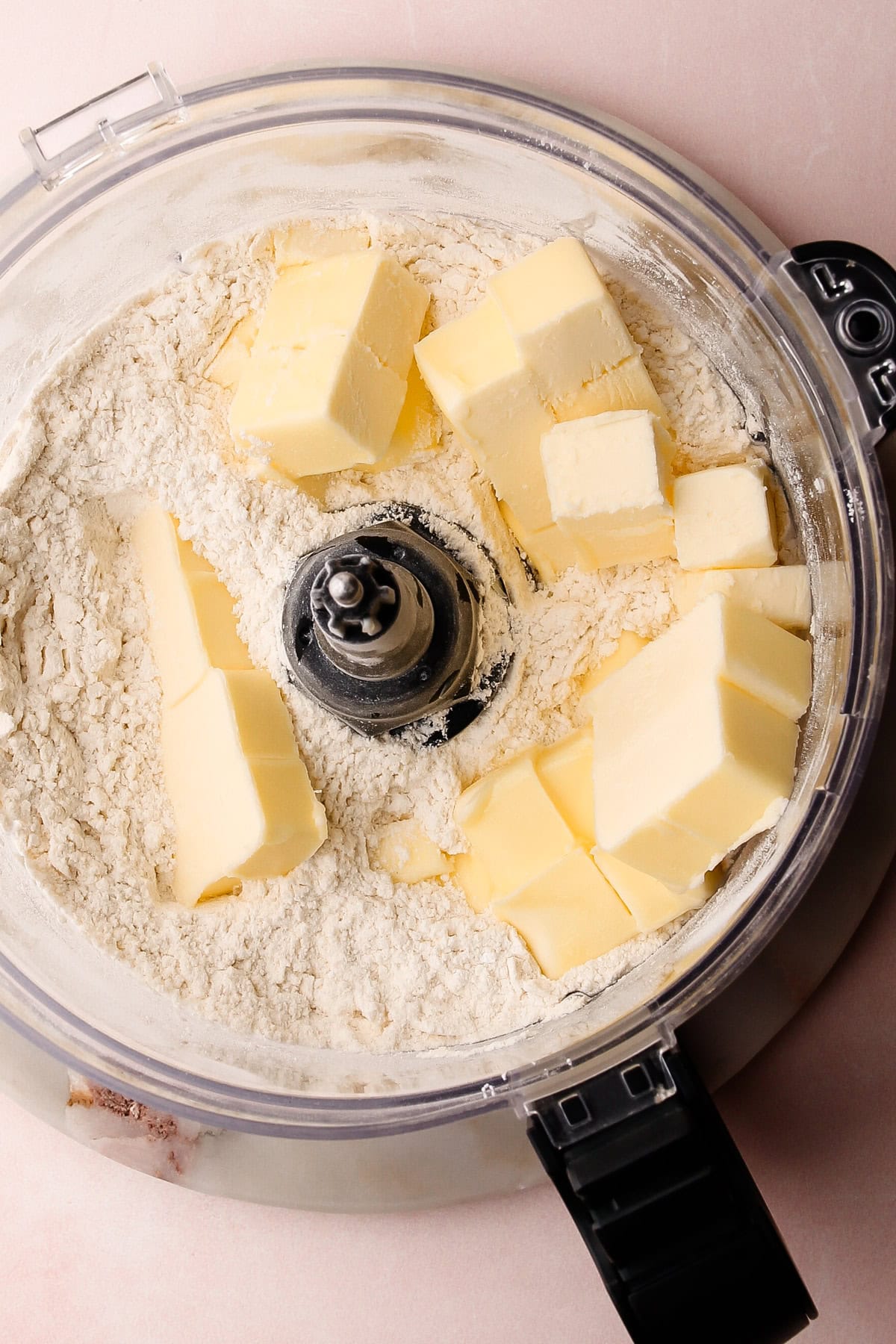 Cubed butter with flour in a food processor.