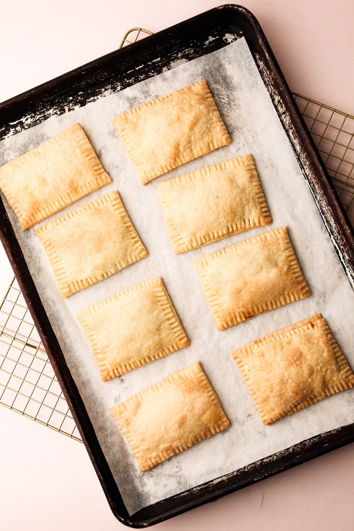 Baked berry pop tarts on a sheet tray.