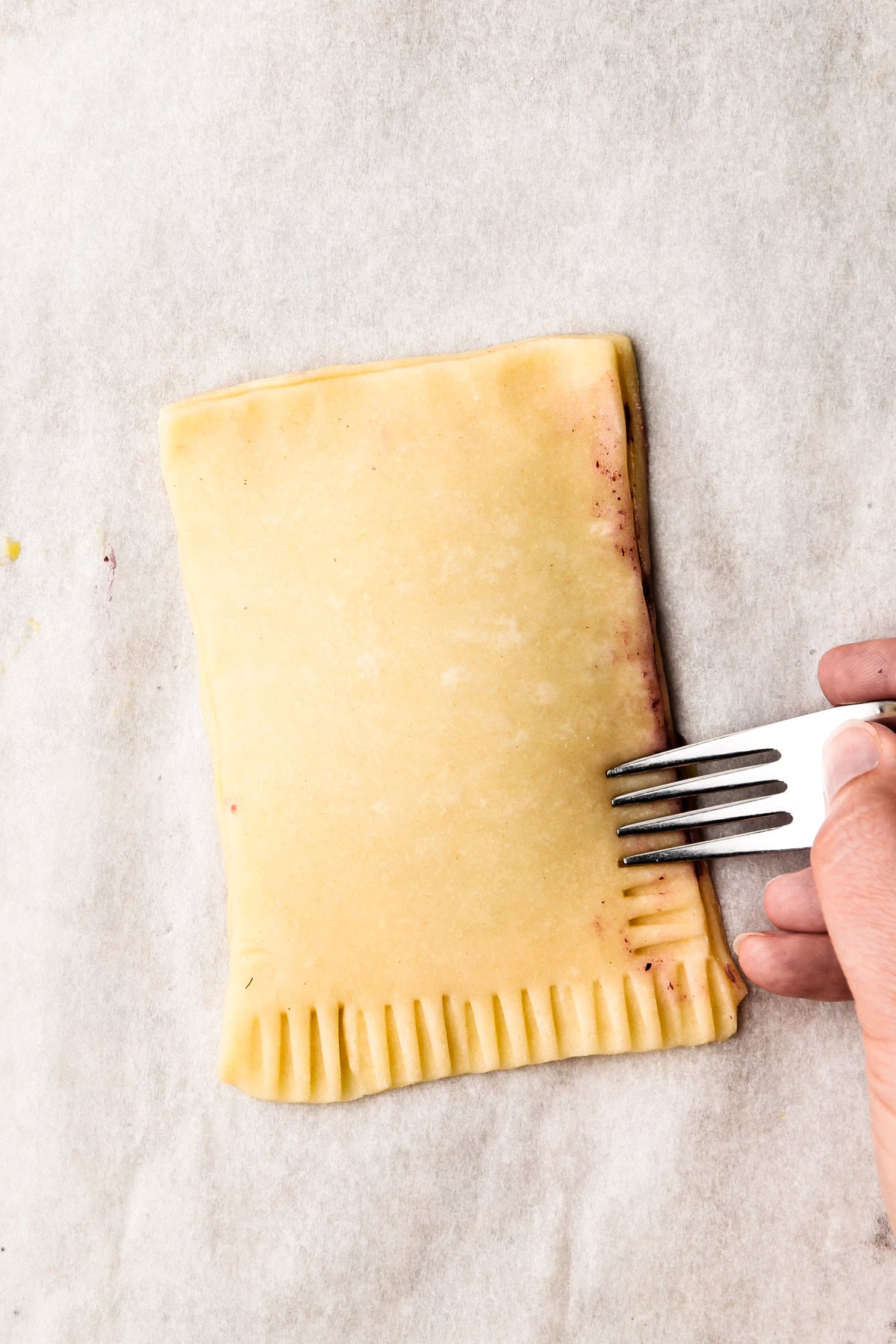 Sealing the pastry of the berry pop tart.