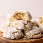 Italian almond cookies baked and stacked with a bit taken from them to reveal the tender interior.