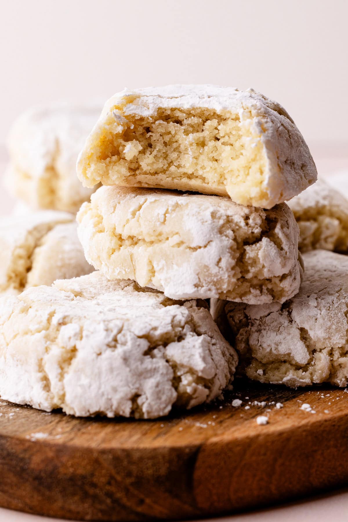 Italian almond cookies baked and stacked with a bit taken from them to reveal the tender interior.