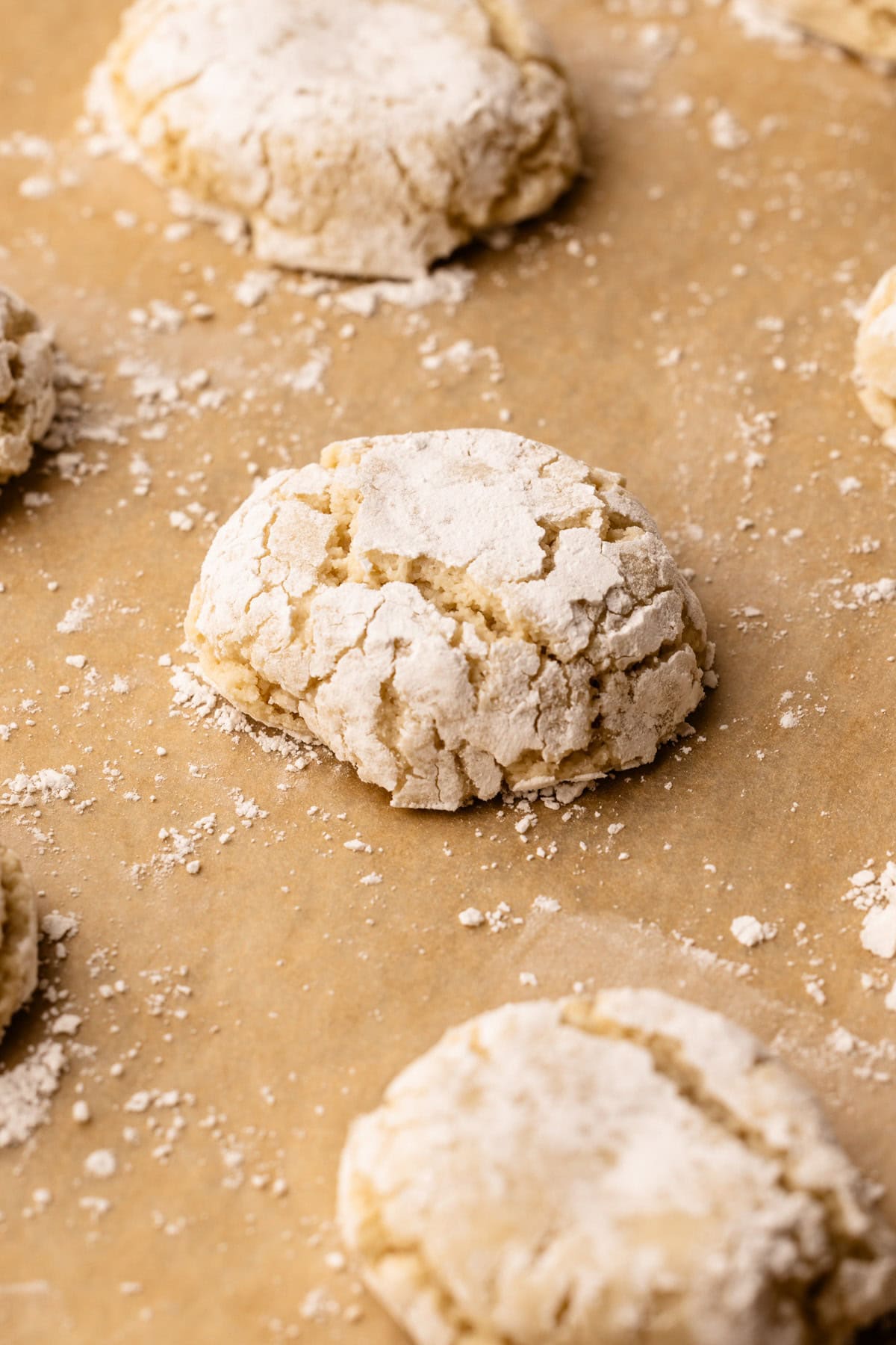 A fully baked Italiam almond cookie on a sheet tray.