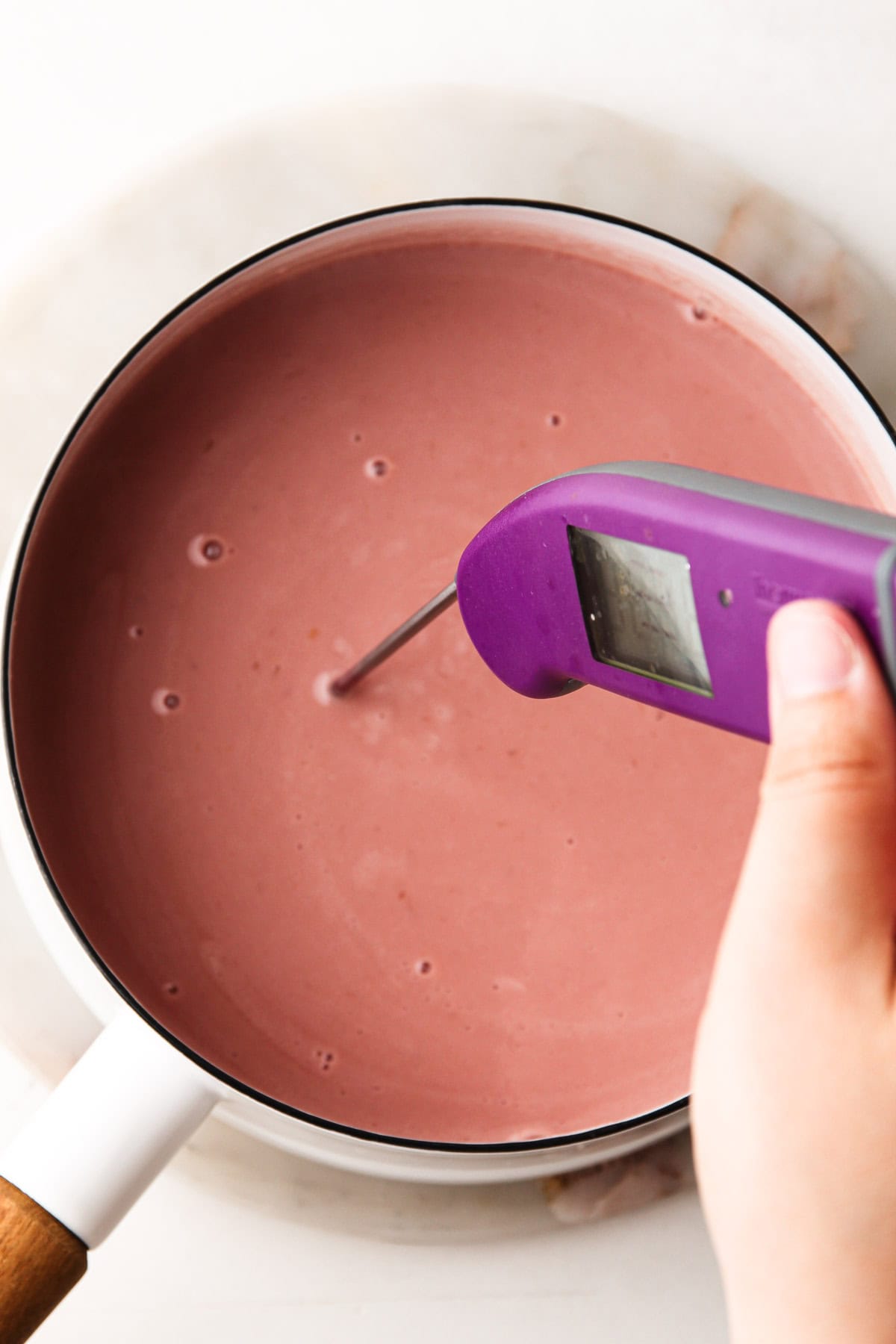 Checking the temperature of a cherry ice cream base.