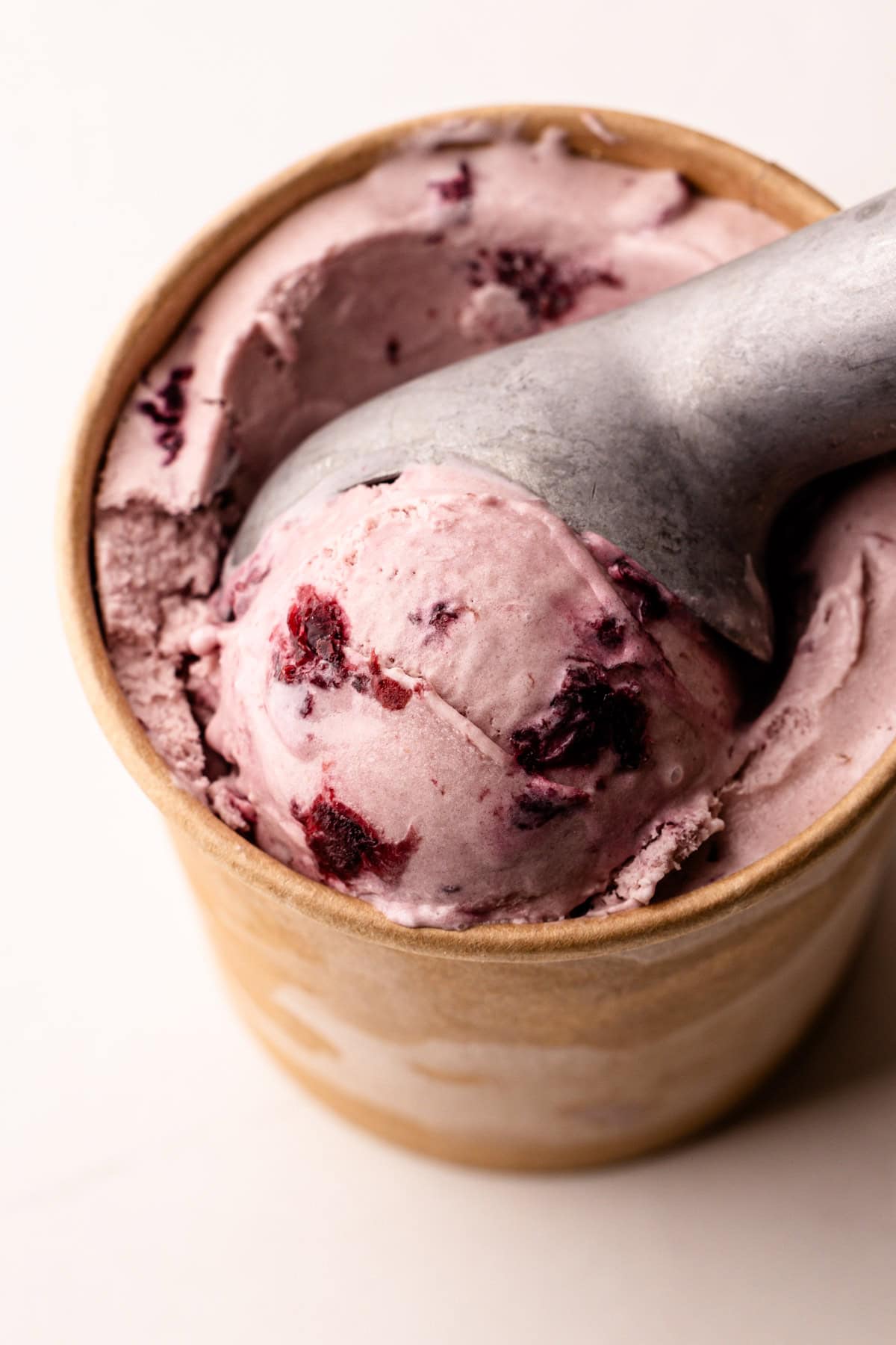 A scoop of a cherry ice cream recipe prepared and frozen.