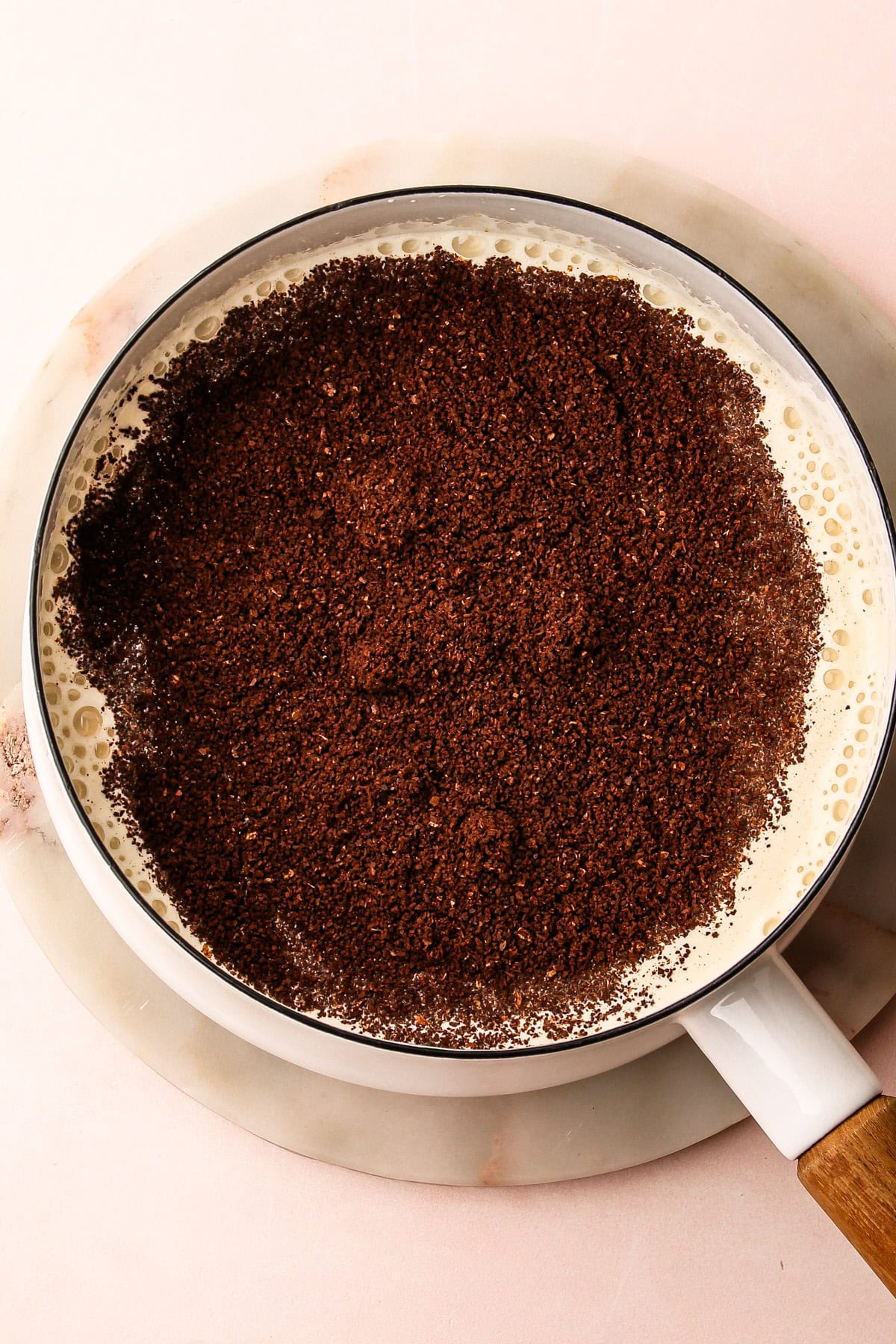 Ingredients for coffee ice cream in a pot before it is cooked.