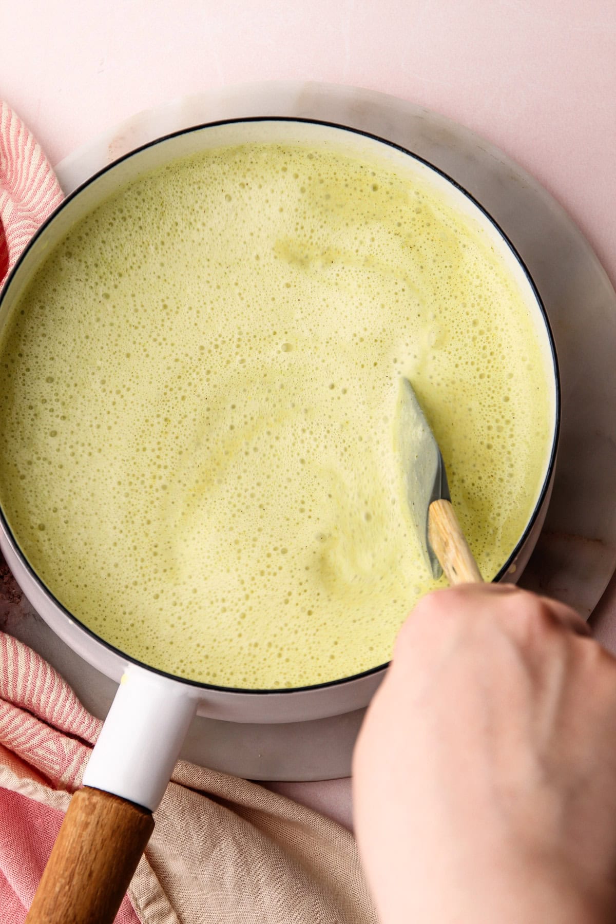 A cooked pistachio ice cream custard in a pot.