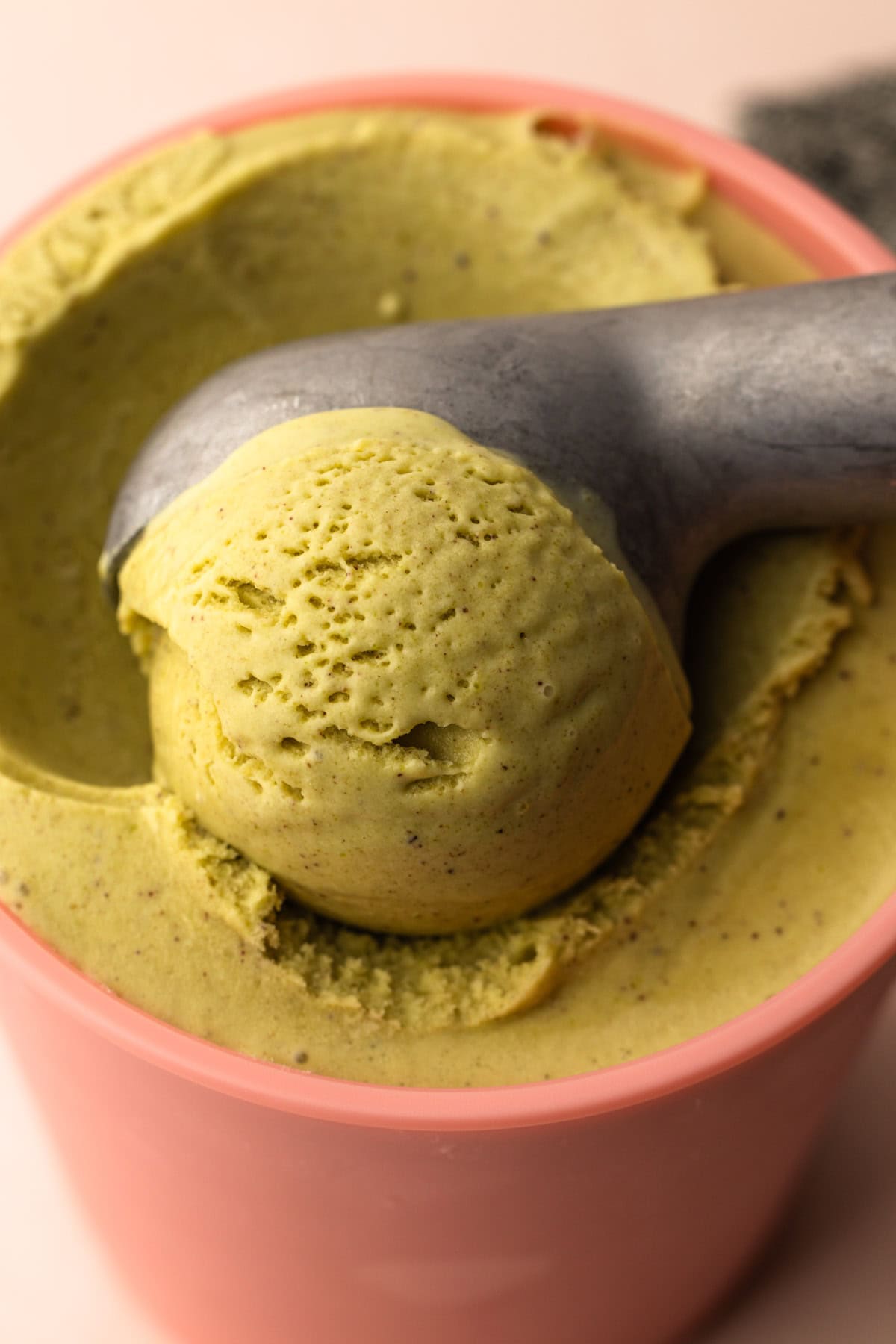 A scoop of a pistachio ice cream recipe from scratch.