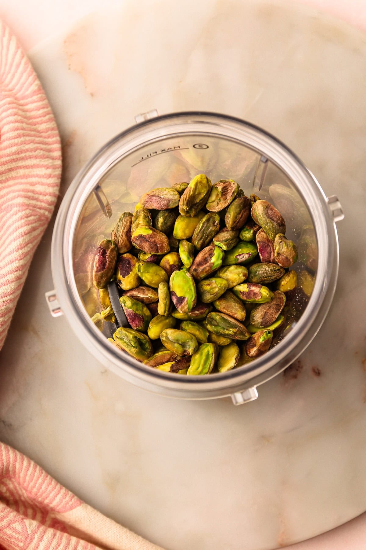 Whole pistachios in a blender.