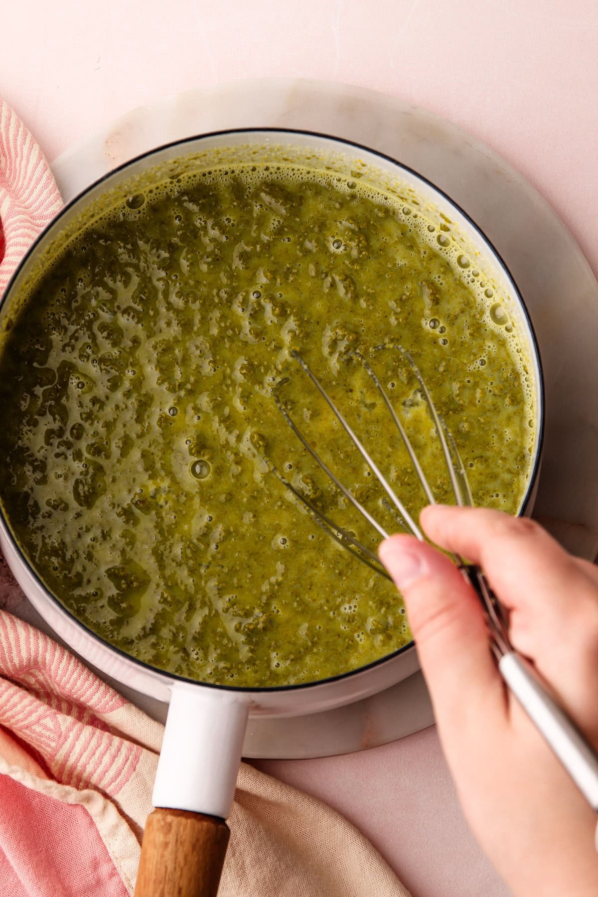 Whisking together pistachio ice cream ingredients.