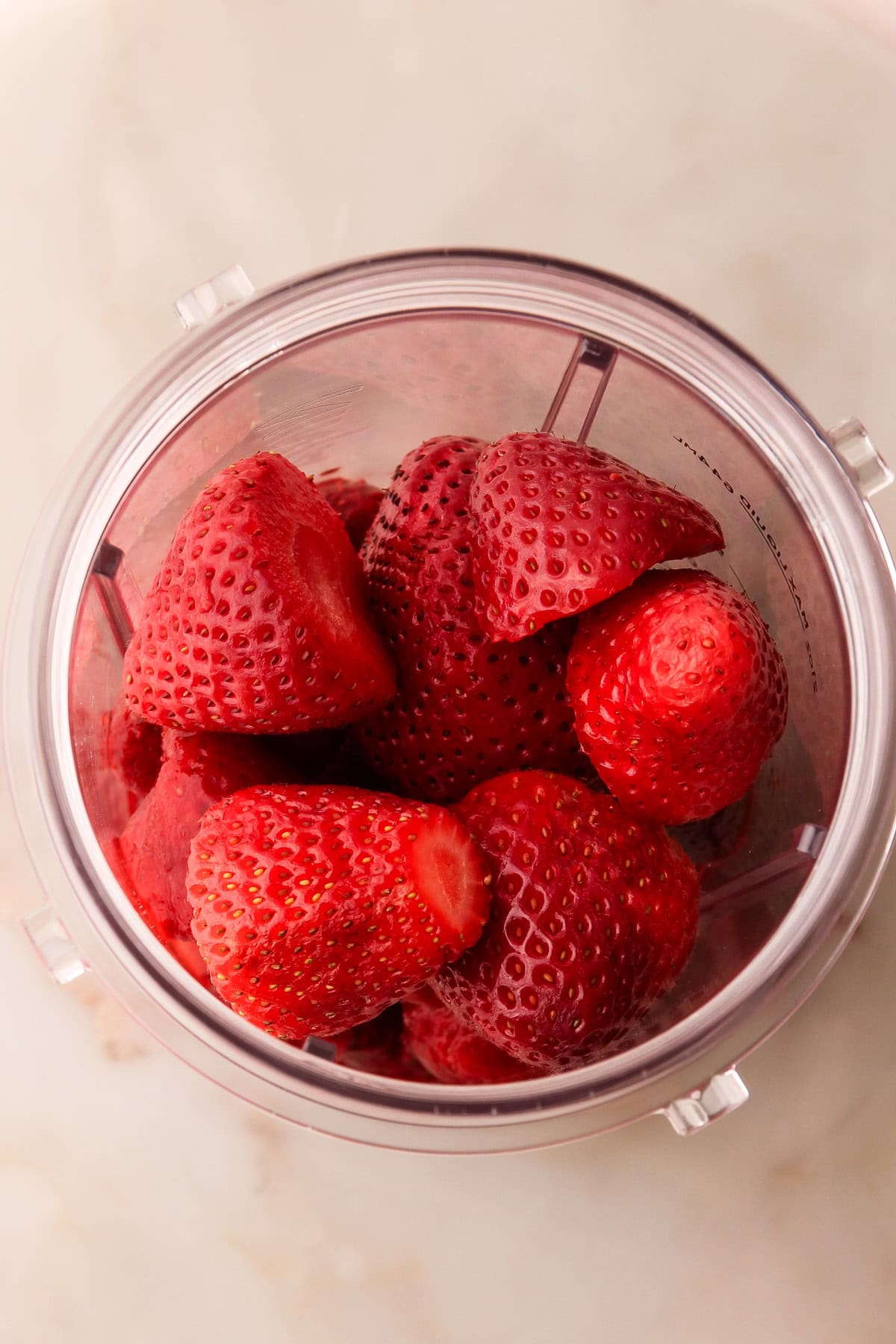 Fresh strawberries in a blender.