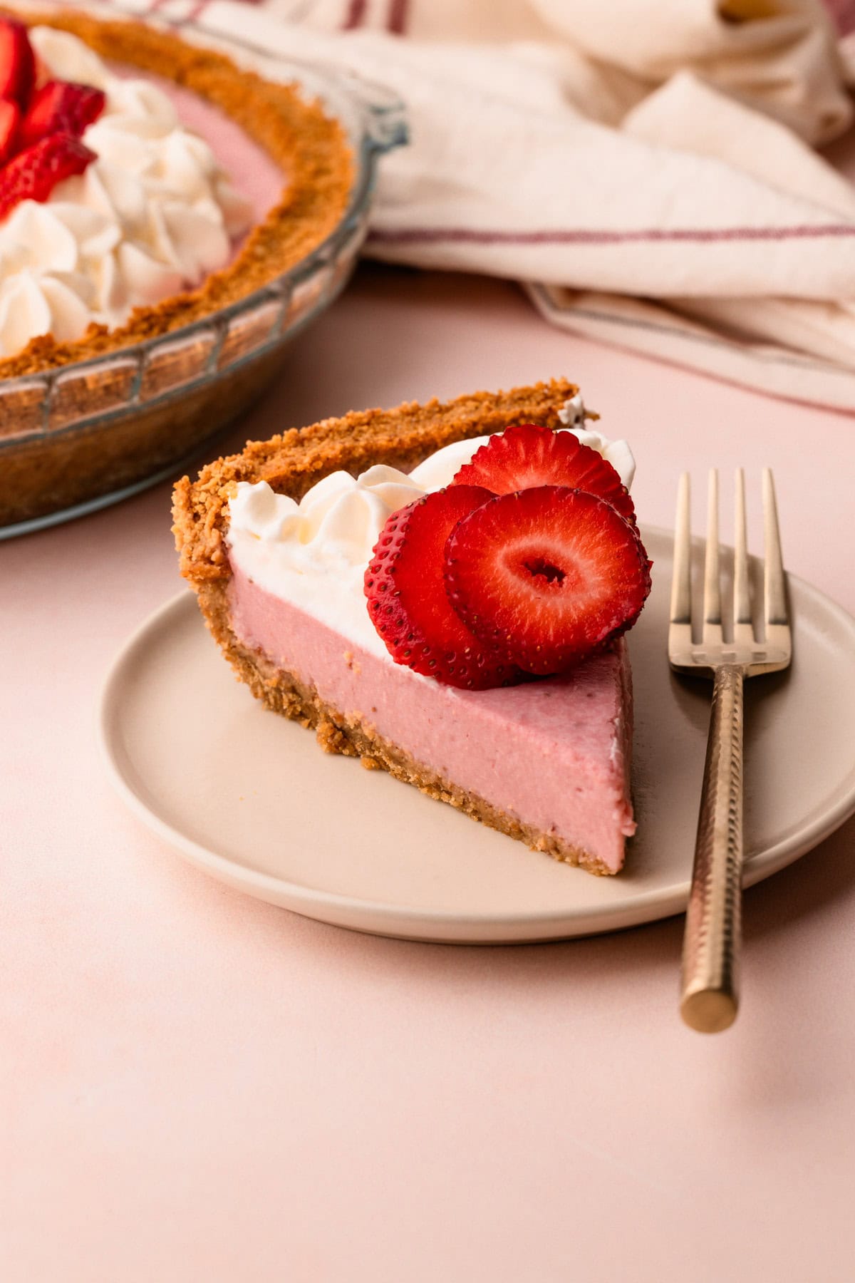 A plated slice of strawberry cream pie.