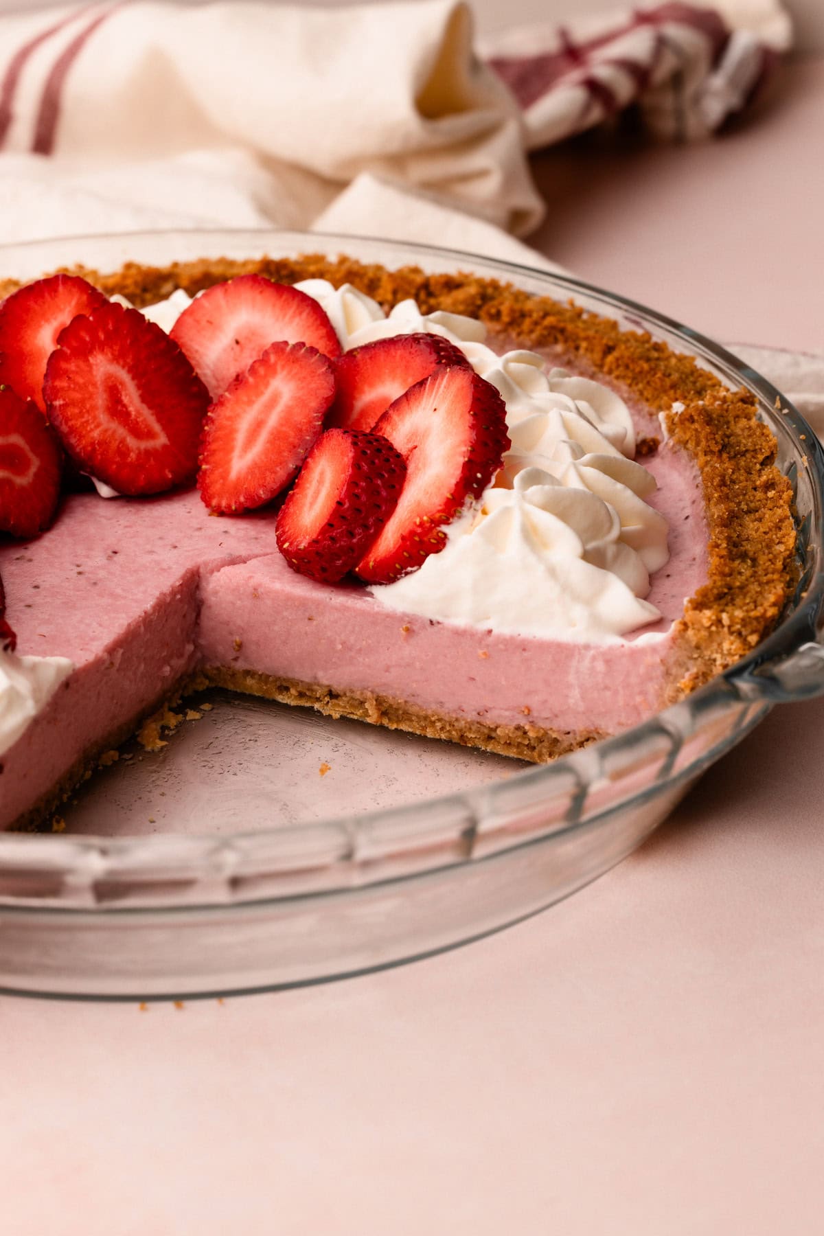 A sliced strawberry cream pie.