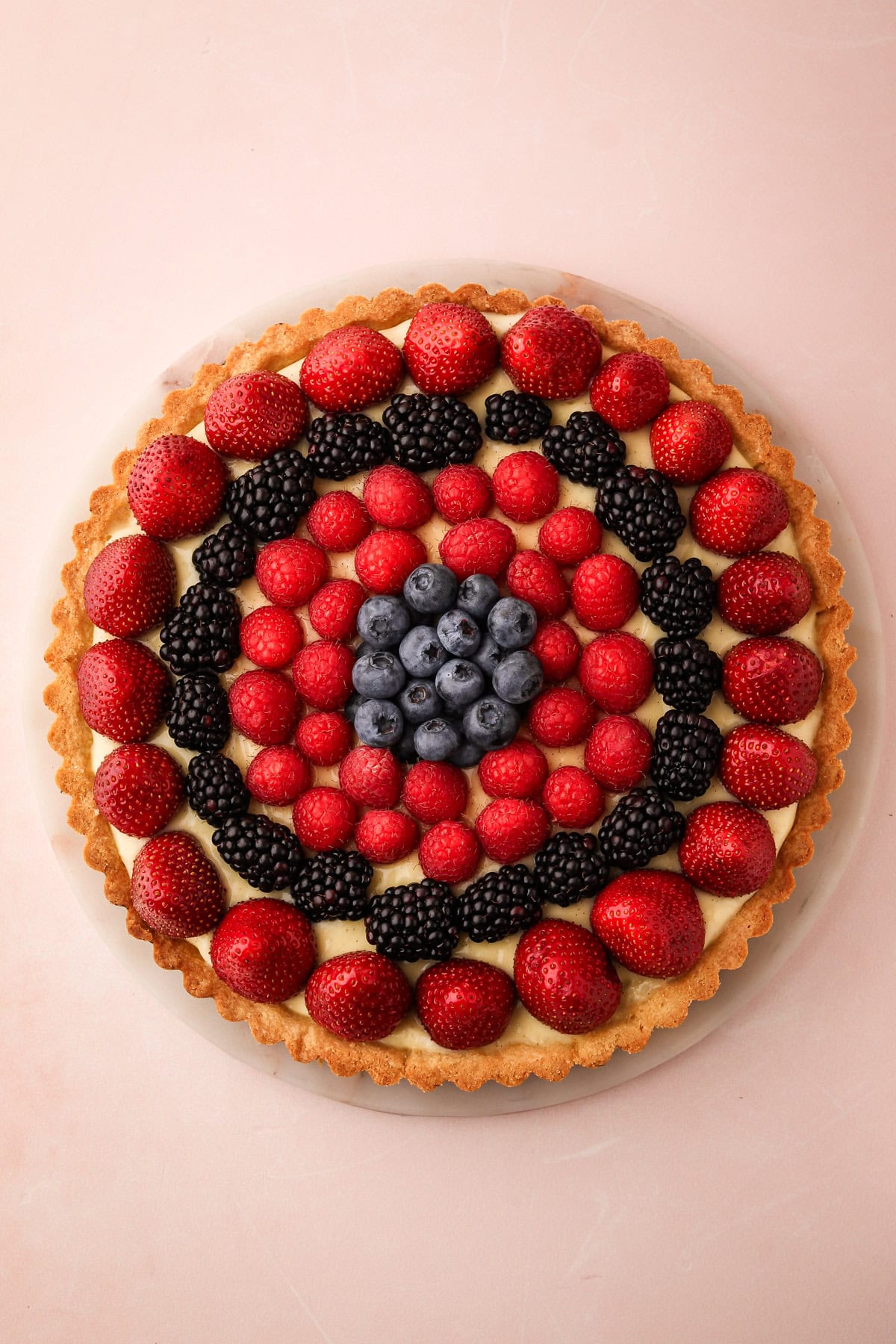 Classic fresh fruit tart with a variety of berries and a vanilla bean pastry cream filling.