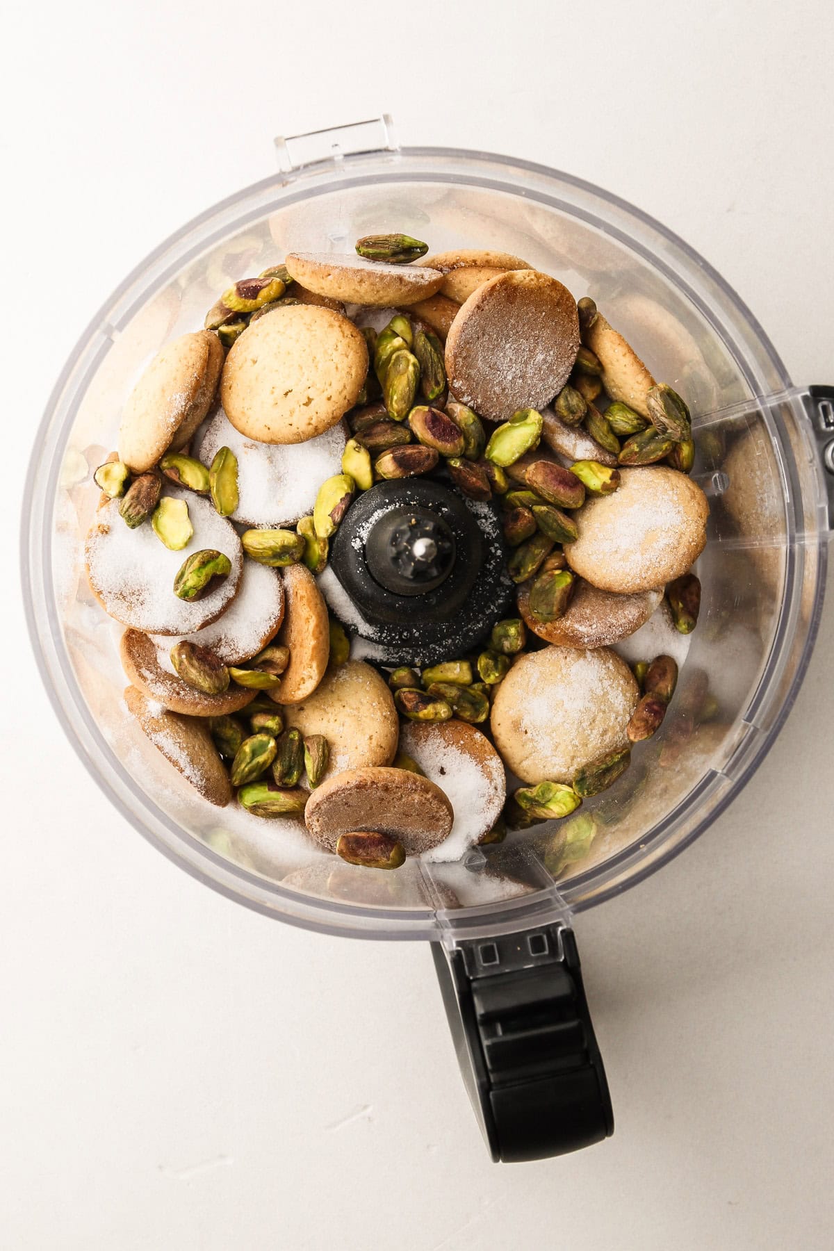 Ingredients for the no-bake cannoli pie crust in a food processor.