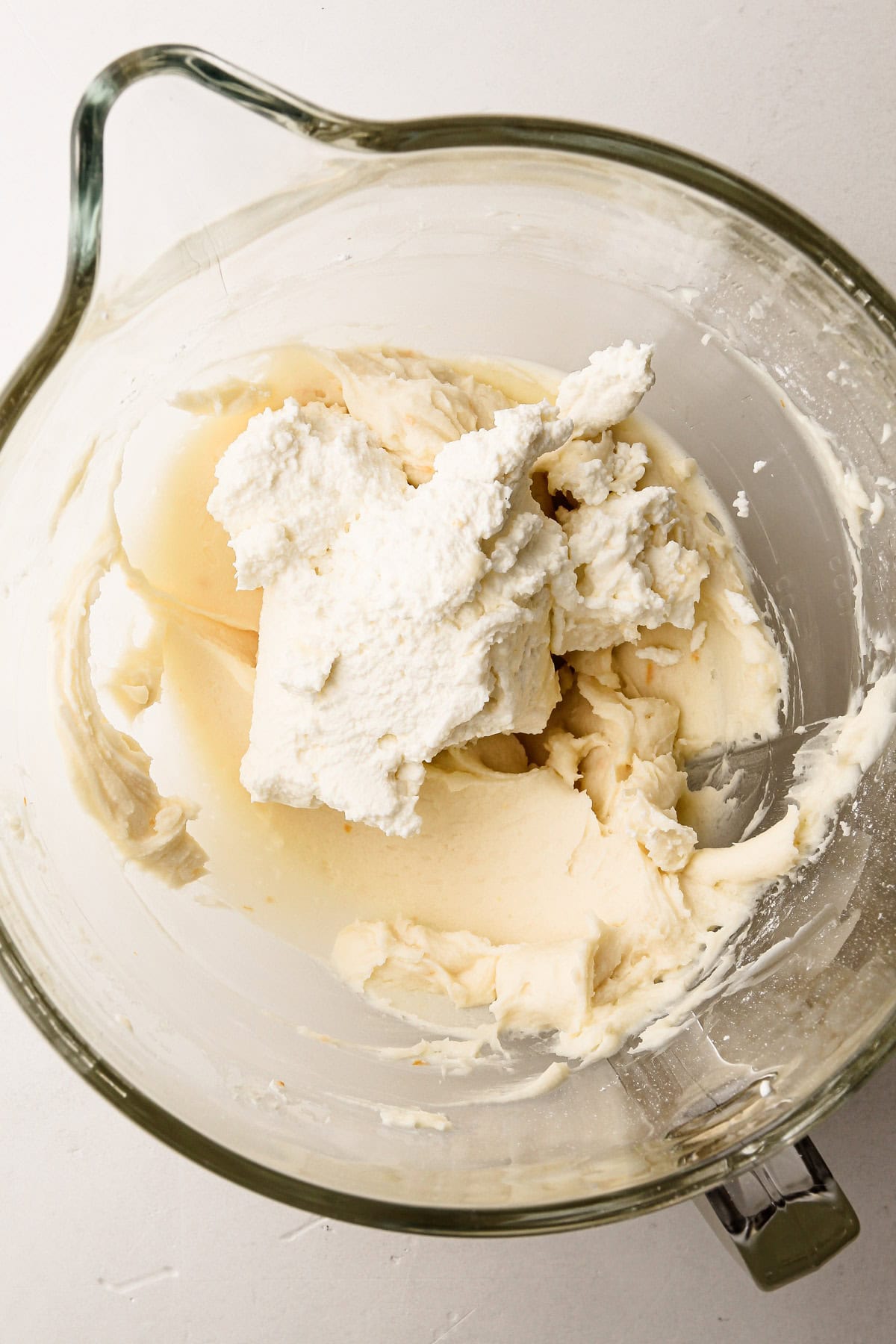 Unmixed creamy filling in a bowl for the cannoli pie.