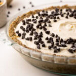 Side view of a no-bake cannoli pie topped with chocolate chips.