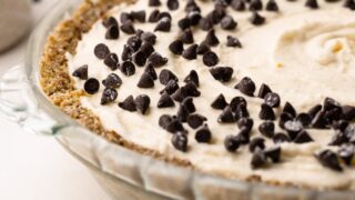 Side view of a no-bake cannoli pie topped with chocolate chips.