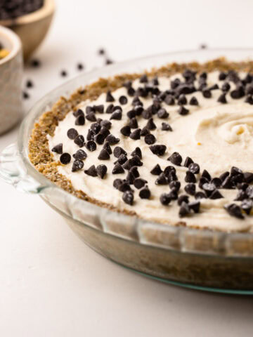 Side view of a no-bake cannoli pie topped with chocolate chips.