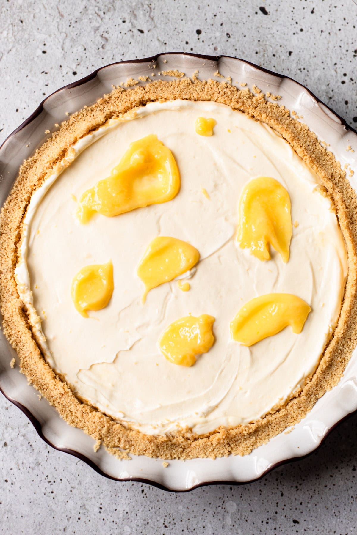 Dollops of lemon curd on top of a no bake lemon pie.